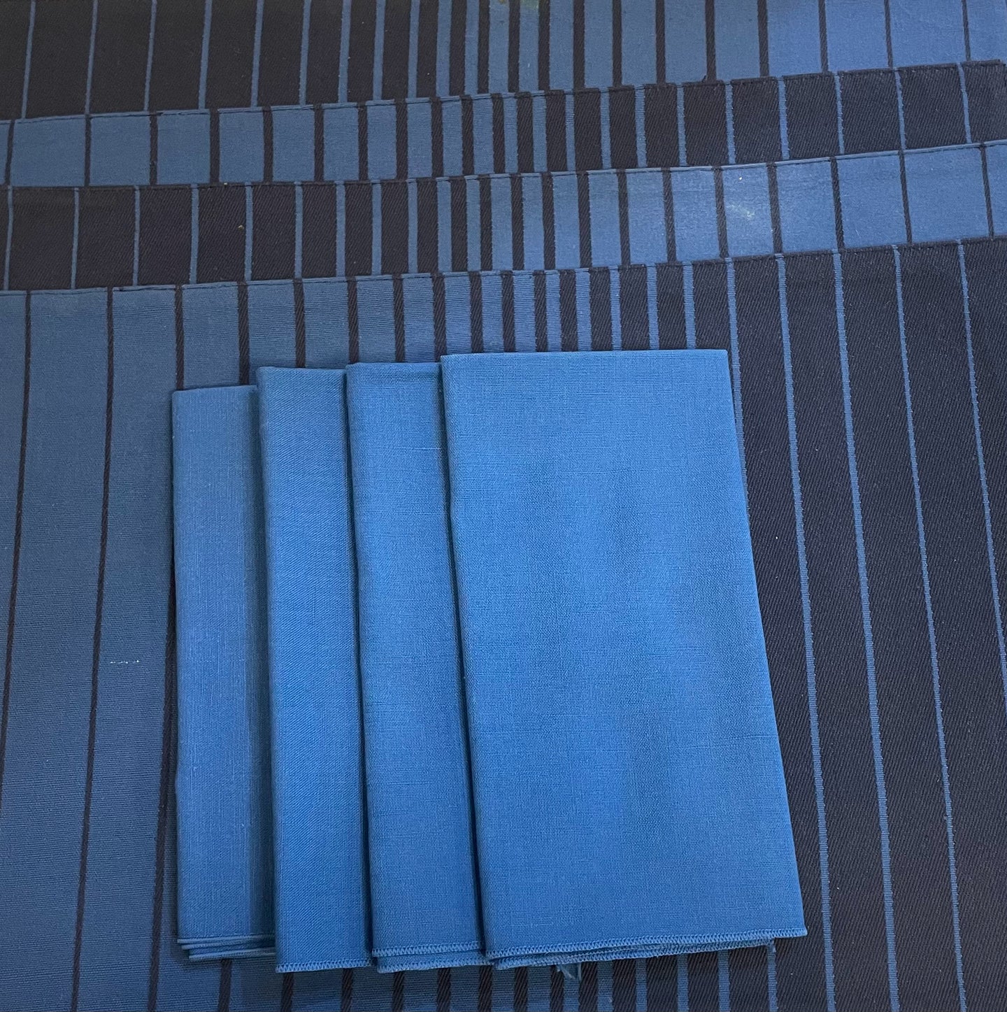 Four Blue Napkins and Striped Placemats